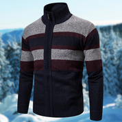 Maglione invernale da uomo a righe blu, grigie e bordeaux, con zip e collo alto, sfondo innevato. Maglione caldo e alla moda per l'inverno.