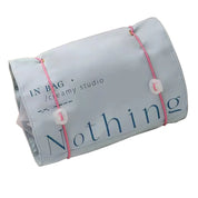 Borsa organizer da viaggio grigia con scritta "Nothing", chiusura con elastici rosa. Ideale per cosmetici, accessori, articoli da toeletta.