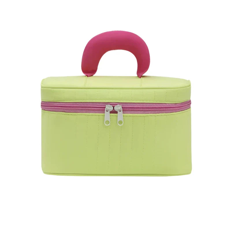 Borsa cosmetica verde chiaro con manico rosa, chiusura a zip doppia. Ideale per trucco, viaggio, organizzazione accessori. Design compatto e moderno.