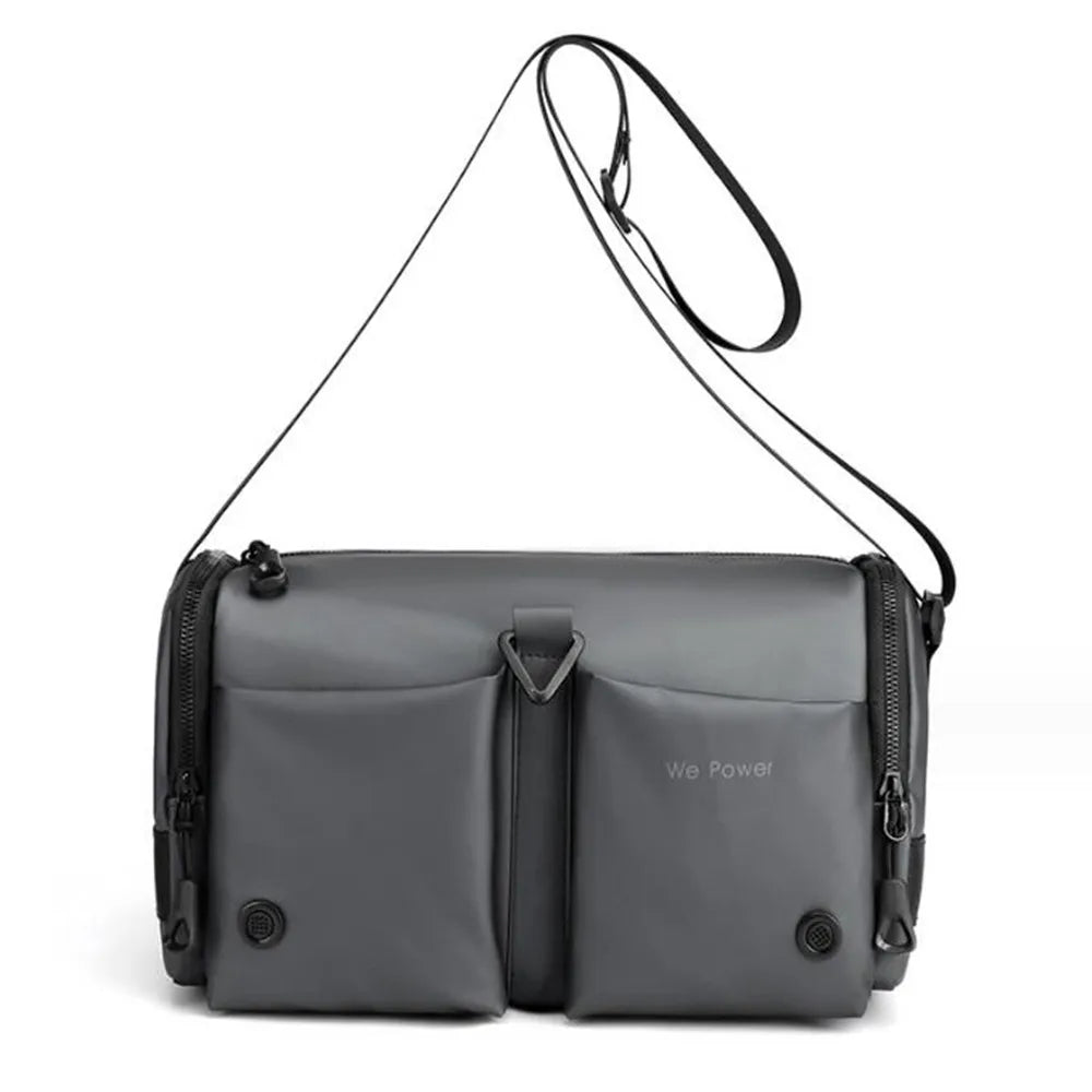 Borsa a tracolla grigia unisex, design moderno, doppie tasche frontali, chiusura a zip, ideale per viaggi e uso quotidiano.