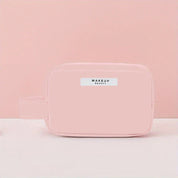 Astuccio trucco rosa pastello con cerniera, design minimalista, ideale per cosmetici e accessori da viaggio. Elegante e pratico per l'organizzazione.