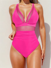 Costume intero donna rosa acceso, design con inserti in rete trasparente, scollo profondo, ideale per moda mare e piscina.