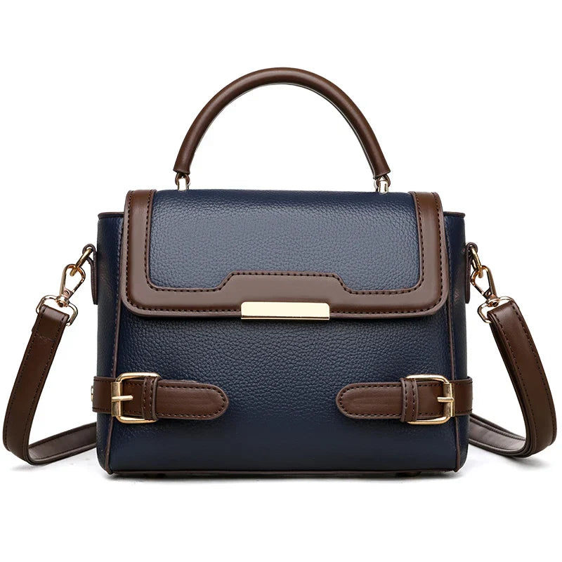 Borsa a tracolla donna in pelle blu e marrone, design elegante con fibbie decorative, manico superiore e tracolla regolabile. Accessorio moda chic.