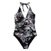 Costume intero donna nero con stampa floreale tropicale, scollo a V, allacciatura al collo. Elegante e ideale per la spiaggia o piscina.