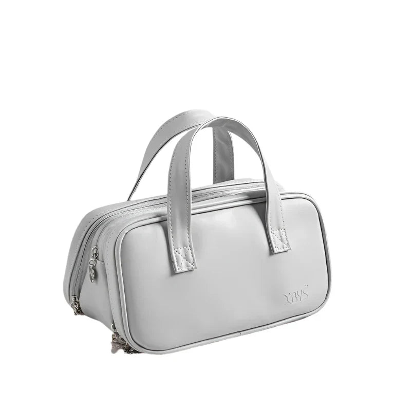 Borsa a mano in pelle bianca, design elegante e moderno, doppio manico, chiusura con zip, ideale per moda donna e accessori di lusso.