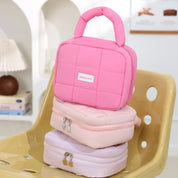 Borsa termica rosa su sedia gialla, design trapuntato, ideale per pranzo al sacco. Accessorio moda pratico e trendy per donne e ragazze.
