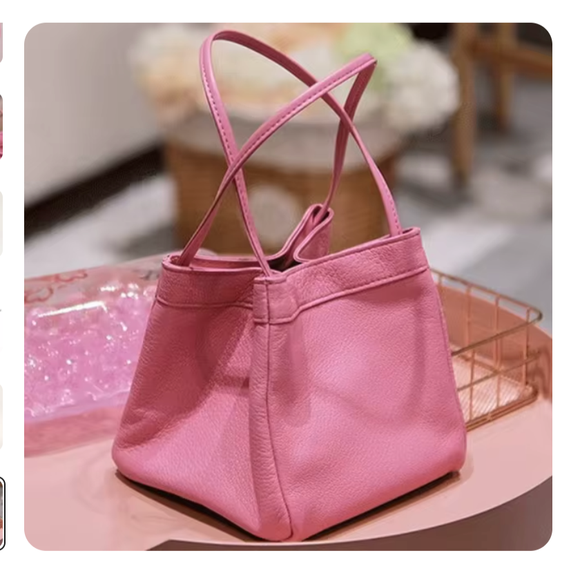 Borsa a mano rosa in pelle, design elegante e moderno, su tavolo in negozio di moda. Accessorio femminile di tendenza, perfetto per ogni occasione.