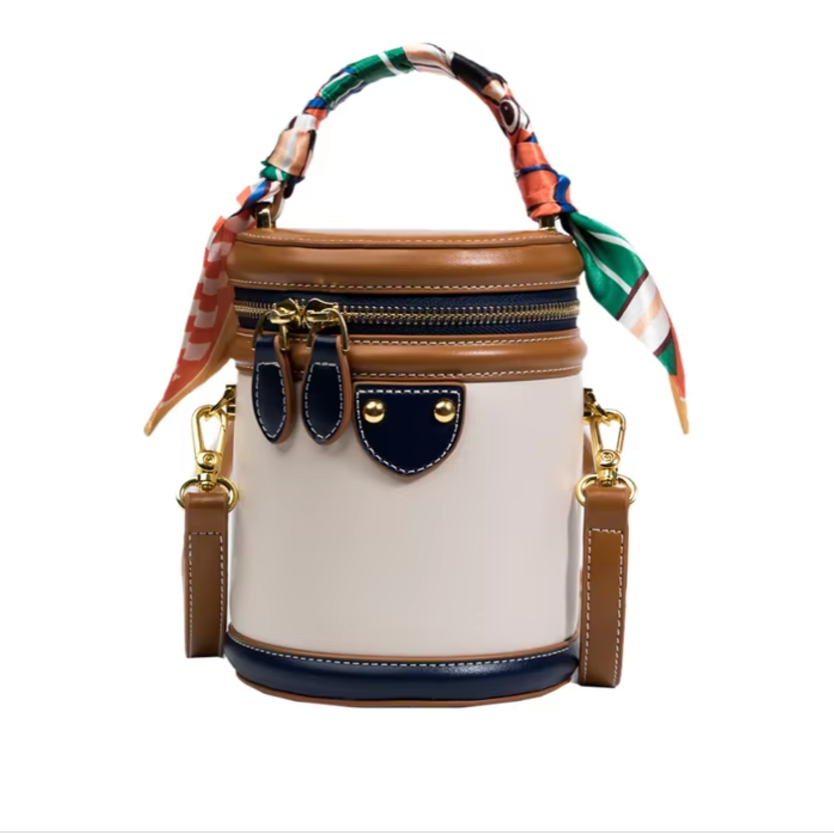 Borsa a secchiello in pelle beige e marrone con manico decorato da foulard colorato, doppia cerniera, dettagli dorati e tracolla regolabile.