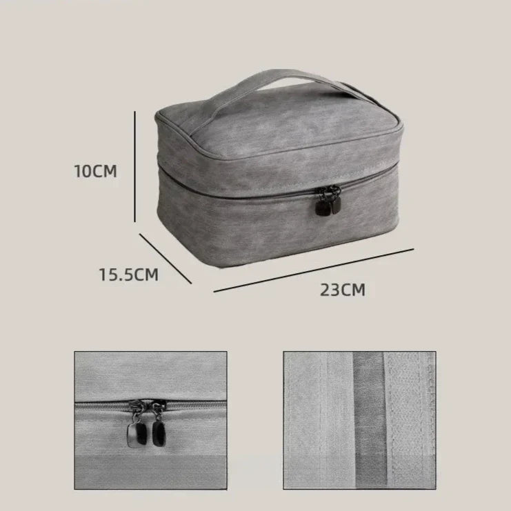 Borsa da viaggio grigia con cerniera, dimensioni 23x15,5x10 cm, manico superiore. Ideale per cosmetici e accessori. Design compatto e pratico.