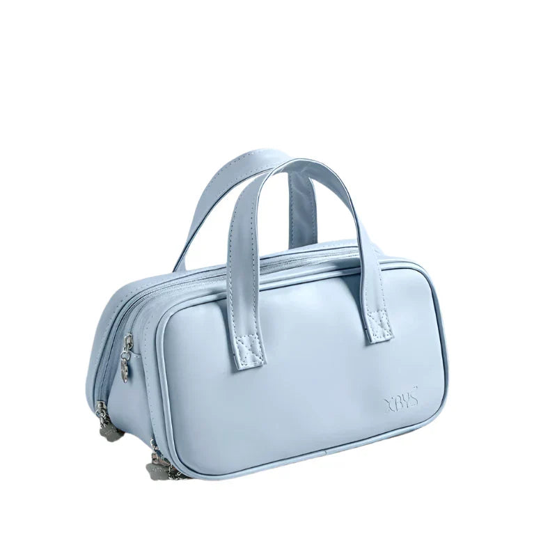 Borsa a mano in pelle azzurra, design elegante e compatto, doppio manico, chiusura con zip, ideale per moda donna e accessori di lusso.