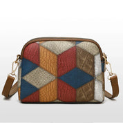 Borsa a tracolla in pelle patchwork multicolore, design geometrico, chiusura con zip, tracolla regolabile, moda donna, accessorio elegante.
