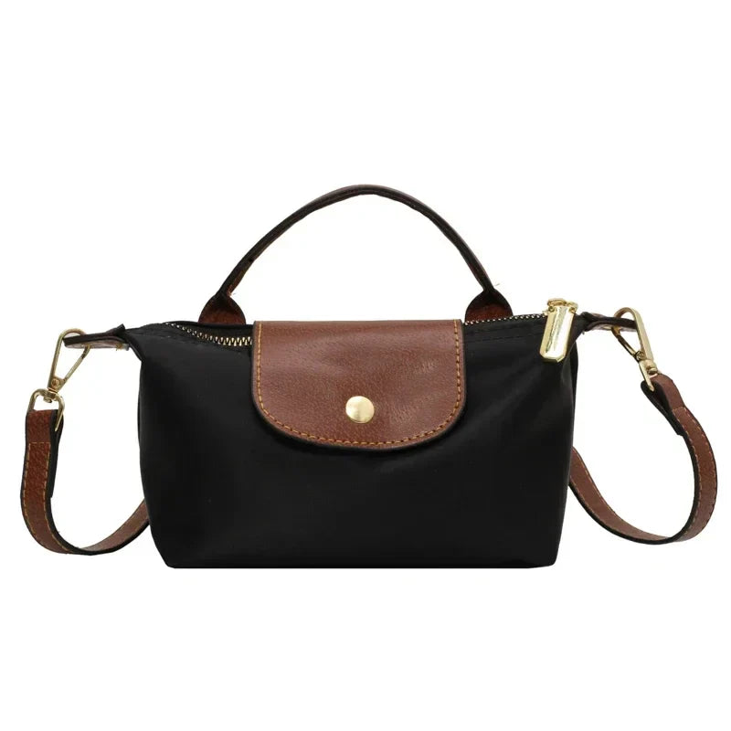 Borsa a tracolla nera con dettagli in pelle marrone, chiusura a zip dorata, manico superiore e tracolla regolabile. Elegante e versatile.
