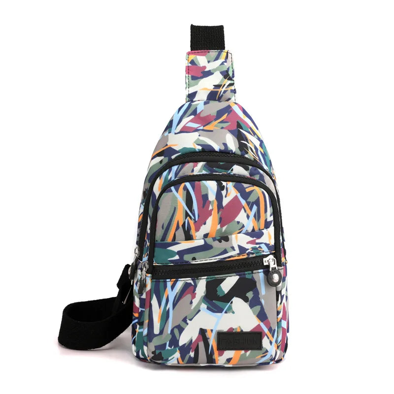 Zaino monospalla multicolore con motivo astratto, tasca frontale con zip, ideale per viaggi e uso quotidiano. Design moderno e pratico.