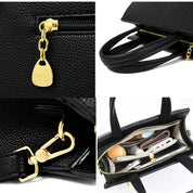 Borsa a mano in pelle nera con dettagli dorati, chiusura a zip, tasche interne organizzate. Elegante accessorio moda donna.