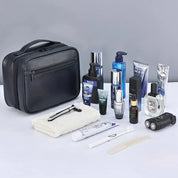 Borsa da toilette nera con prodotti per la cura maschile: dopobarba, crema viso, rasoio, profumo, shampoo, spazzolino, pettine, kit da viaggio uomo.