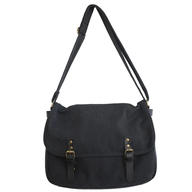 Borsa a tracolla nera in tela con fibbie in pelle, design elegante e resistente, ideale per uso quotidiano e viaggi. Accessorio moda unisex.