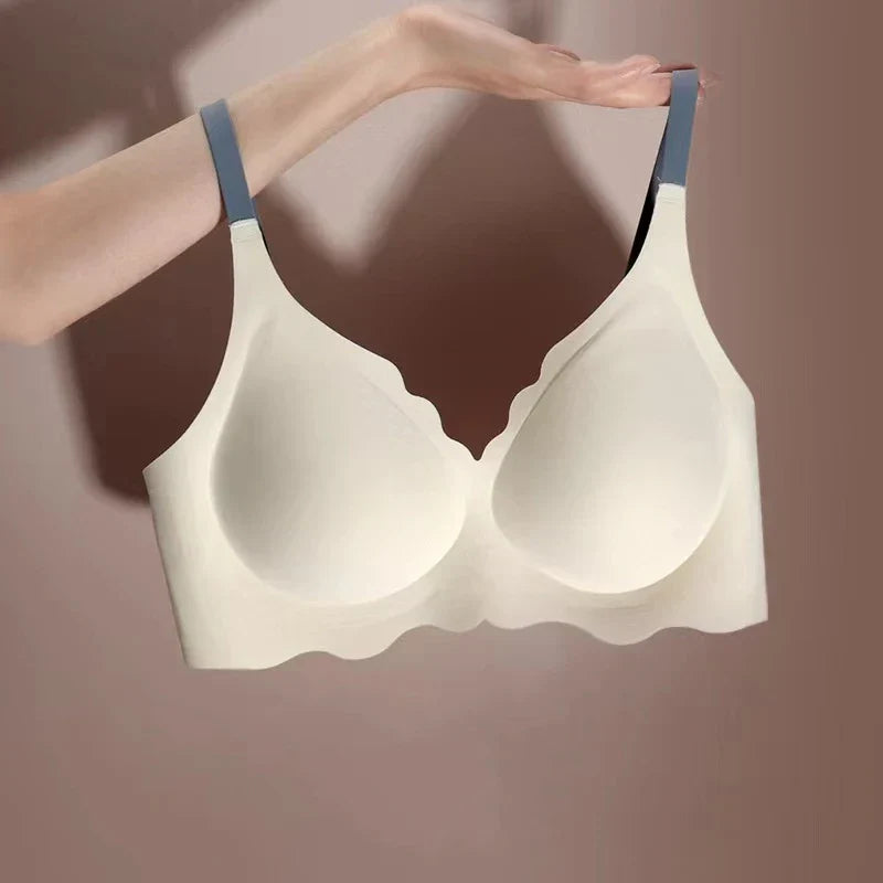 Reggiseno senza cuciture color crema con spalline grigie, design a onde, supporto confortevole, ideale per abbigliamento quotidiano.