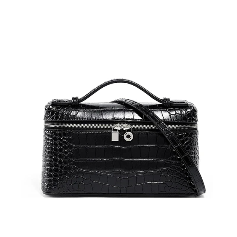 Borsa a tracolla in pelle nera effetto coccodrillo, con manico superiore e chiusura a zip. Design elegante e moderno per moda donna.