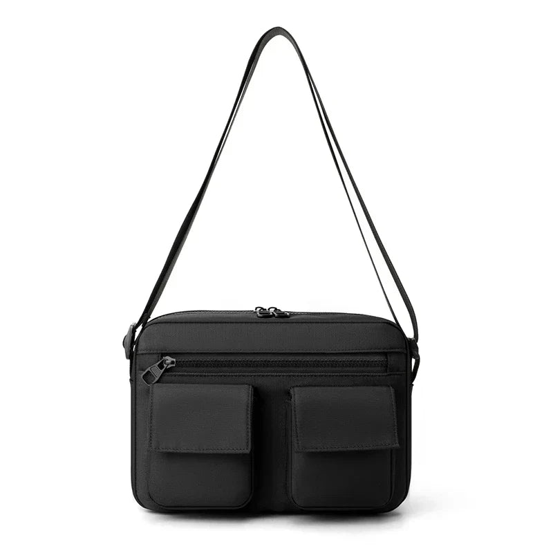 Borsa a tracolla nera in pelle con doppie tasche frontali, design elegante e moderno, ideale per uomo e donna. Accessorio moda versatile.