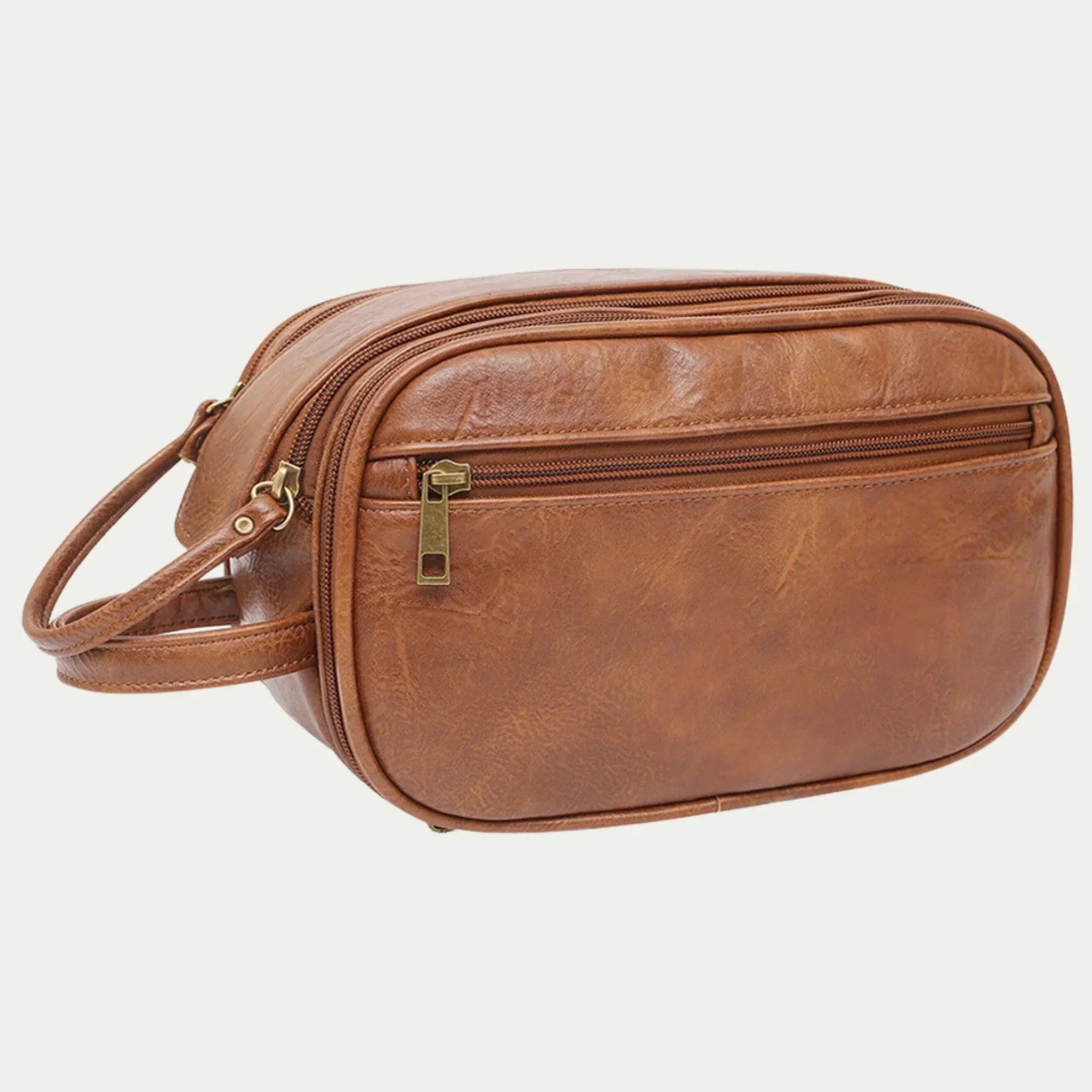 Borsa da toilette in pelle marrone, design elegante con cerniera frontale, ideale per viaggi. Accessorio moda uomo, alta qualità artigianale.