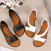 Sandali estivi da donna in pelle nera e bianca, design aperto, suola antiscivolo, ideali per moda casual e comfort quotidiano.
