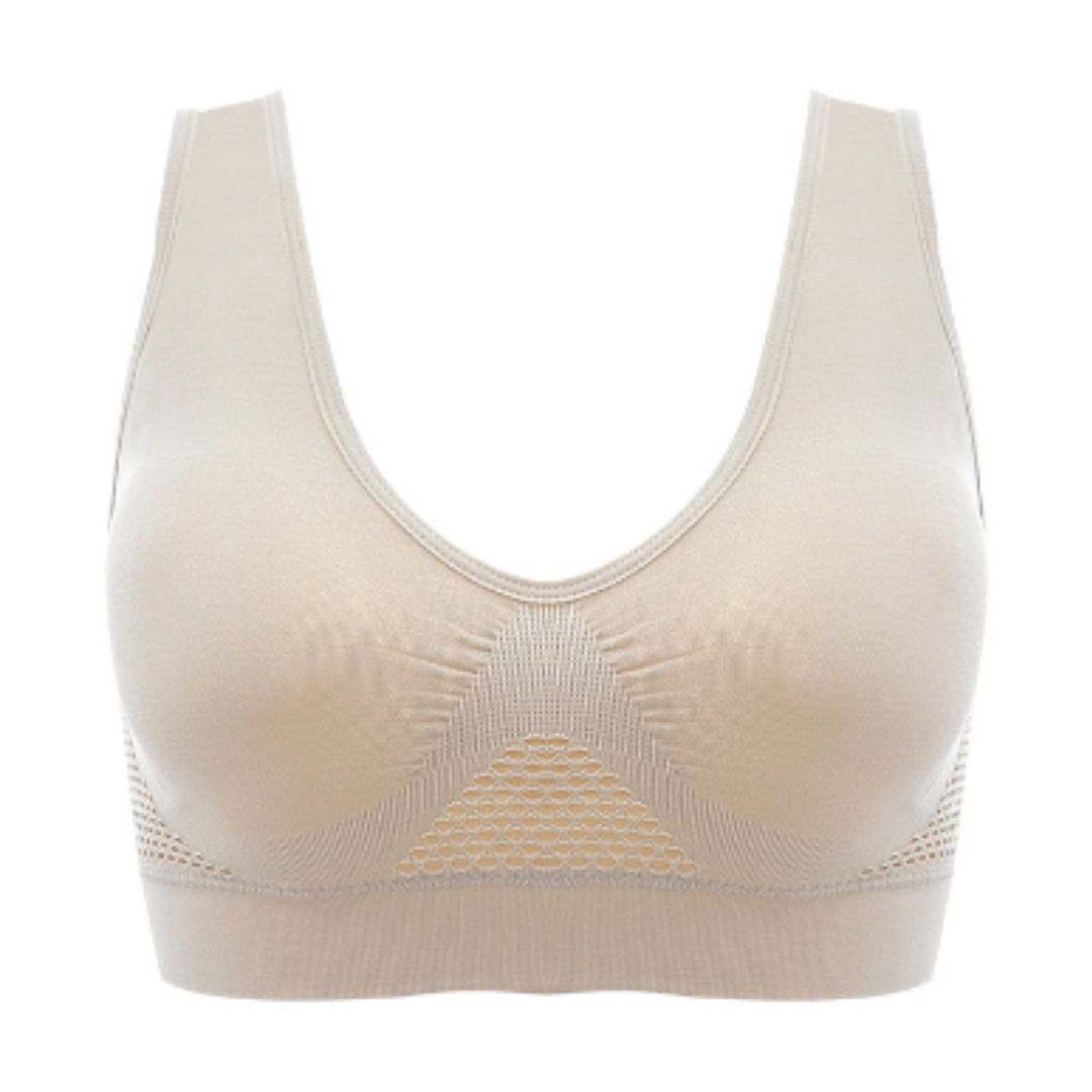 Reggiseno sportivo beige senza cuciture, design a rete traspirante, supporto confortevole, ideale per attività sportive e fitness.