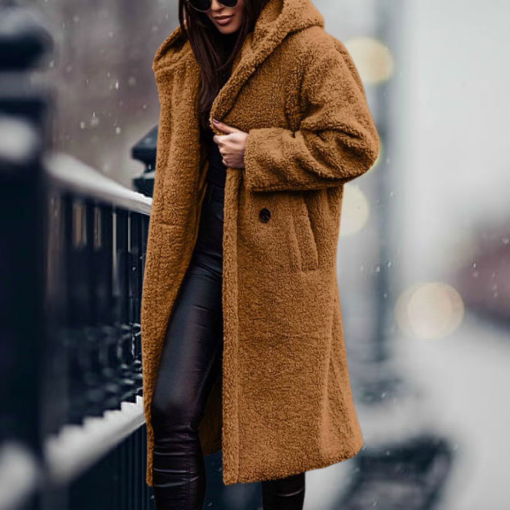Cappotto lungo in pelliccia sintetica marrone, donna, moda invernale, elegante, caldo, con cappuccio, abbinato a pantaloni neri, strada innevata.