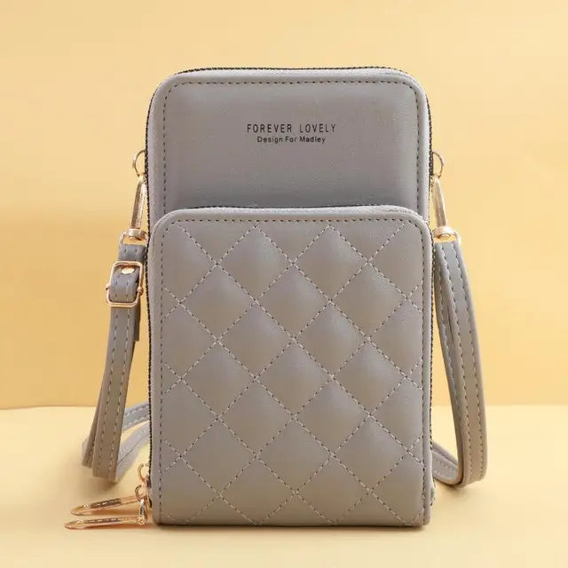 Borsa a tracolla grigia in pelle trapuntata, design compatto con doppia tasca, cerniere dorate, ideale per smartphone e accessori.