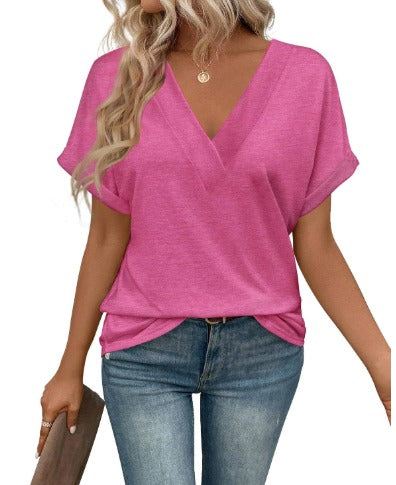 Donna con maglia rosa a V, maniche corte, abbinata a jeans blu. Moda casual femminile, abbigliamento estivo, stile trendy.