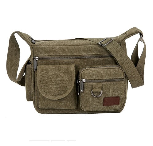 Borsa a tracolla in tela verde oliva con tasche multiple e cerniere, ideale per uomo e donna. Design pratico e resistente, perfetto per viaggi e uso quotidiano.