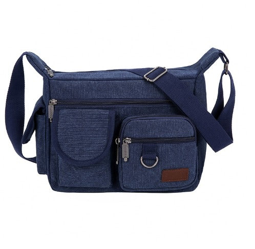 Borsa a tracolla in tela blu con tasche multiple e cerniere, design unisex, ideale per viaggi e uso quotidiano. Accessorio moda pratico e resistente.