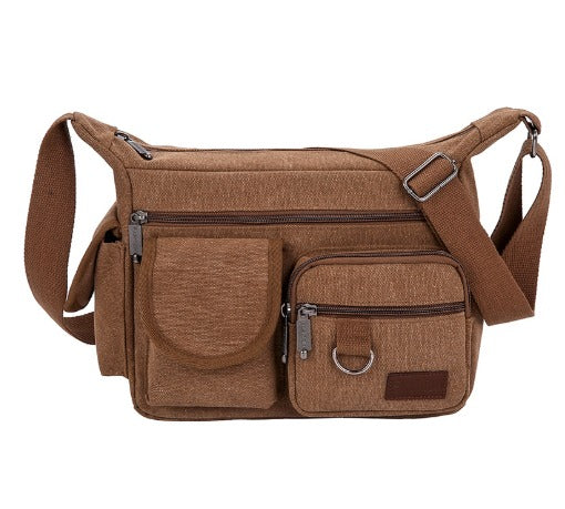 Borsa a tracolla in tela marrone con tasche multiple e cerniere, design unisex, ideale per viaggi e uso quotidiano. Accessorio moda pratico e resistente.