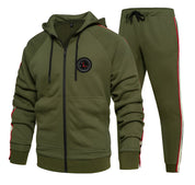 Tuta sportiva verde oliva con cappuccio, zip frontale e pantaloni abbinati. Dettagli a righe rosse e bianche, ideale per allenamento e tempo libero.