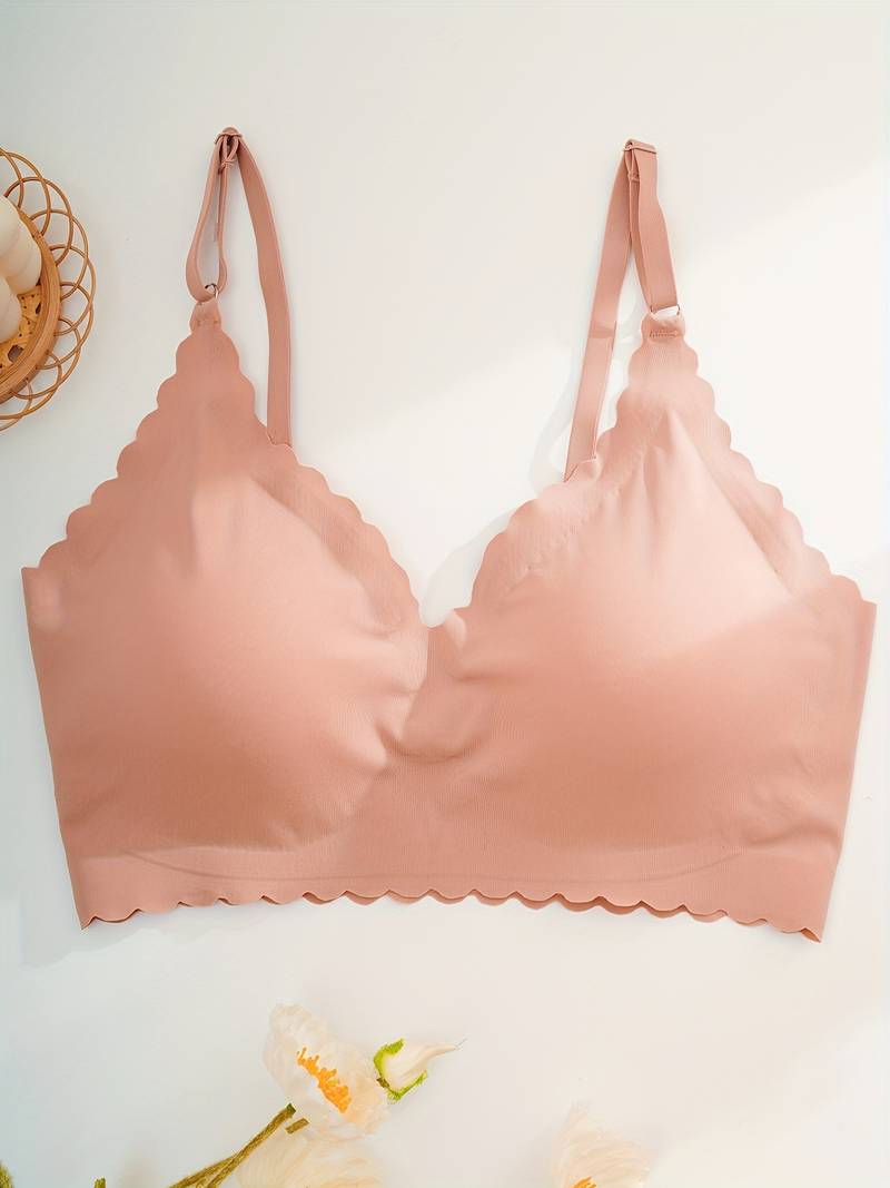 Reggiseno senza cuciture rosa, design a triangolo, spalline regolabili, bordo ondulato. Intimo comodo e moderno per donna.
