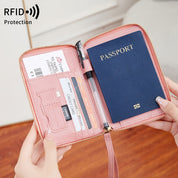 Portafoglio da viaggio rosa con protezione RFID, contiene passaporto, carte di credito e biglietto aereo. Accessorio essenziale per viaggi sicuri.