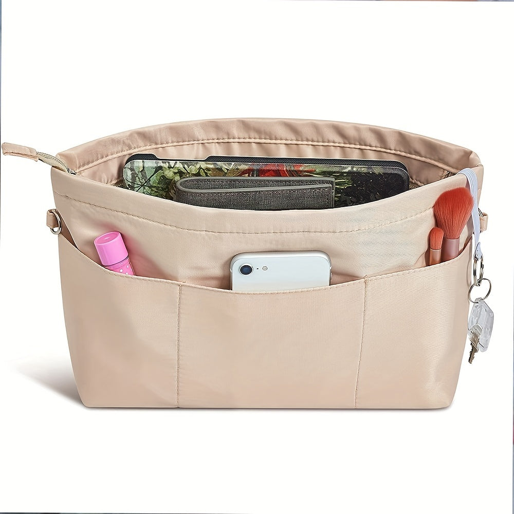 Organizer borsa beige con tasche multiple, contenente smartphone, pennelli trucco e accessori. Ideale per organizzazione borsa donna.