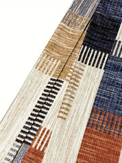 Tessuto a righe multicolore con motivi geometrici, tonalità blu, marrone e beige. Ideale per arredamento e moda. Design moderno e versatile.