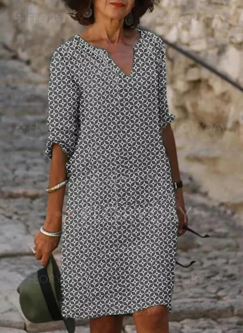 Abito donna estivo a maniche lunghe, motivo geometrico bianco e nero, scollo a V, stile casual, perfetto per moda femminile e abbigliamento quotidiano.