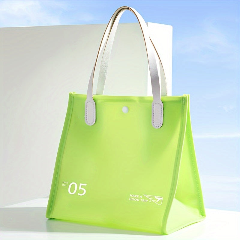 Borsa tote verde chiaro in PVC trasparente con manici bianchi, design moderno, ideale per shopping e viaggi. Accessorio moda estivo.