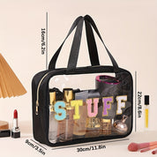 Borsa trasparente da viaggio con manici neri, scritta "STUFF", contenente cosmetici e accessori. Dimensioni: 30x9x16 cm. Ideale per organizzare trucchi.