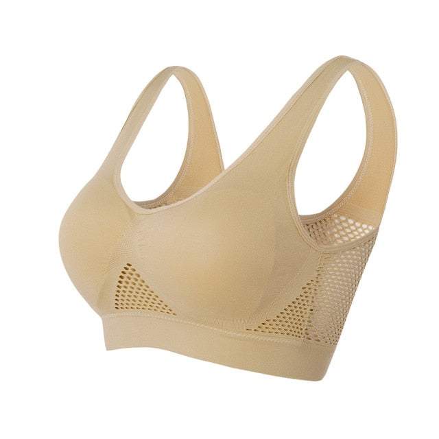 Reggiseno sportivo beige senza cuciture, design traspirante con inserti a rete, supporto confortevole, ideale per attività sportive e quotidiane.
