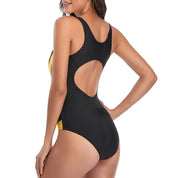 Costume intero donna nero e giallo, design con schiena scoperta, moda mare 2023, tessuto elastico, ideale per nuoto e spiaggia.