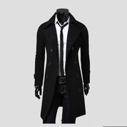 Cappotto nero elegante da uomo, doppio petto, abbinato a camicia bianca e cravatta nera. Moda maschile autunno inverno, stile classico.