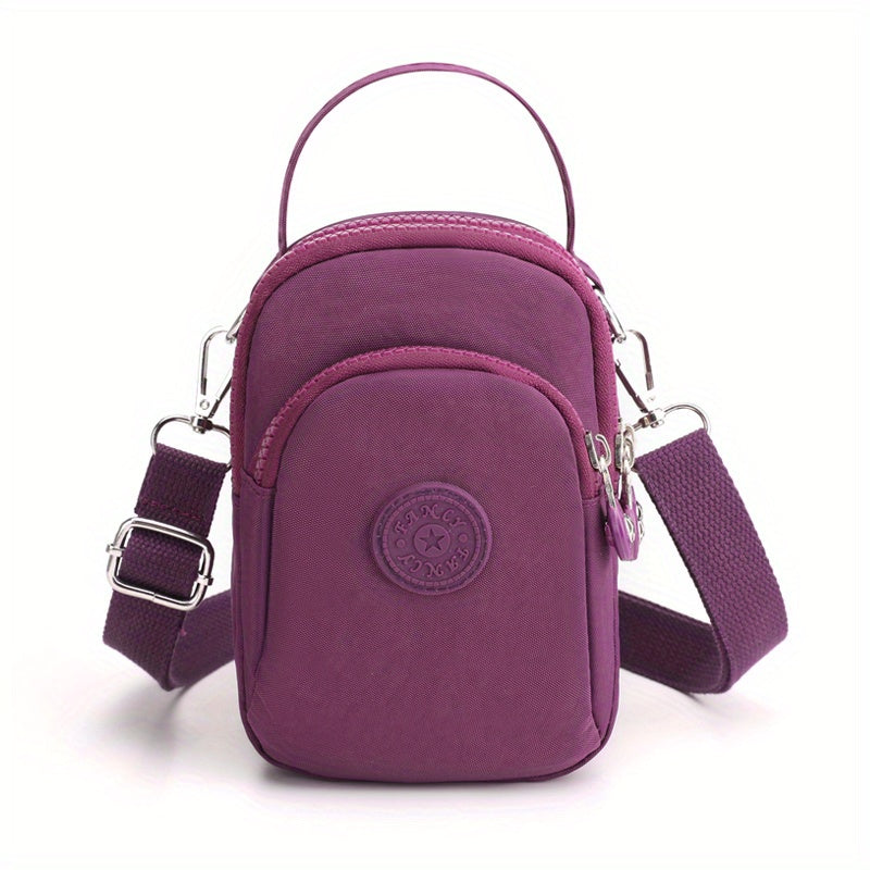 Borsa a tracolla viola in nylon, compatta e resistente, con tasca frontale e cerniera. Ideale per viaggi e uso quotidiano.