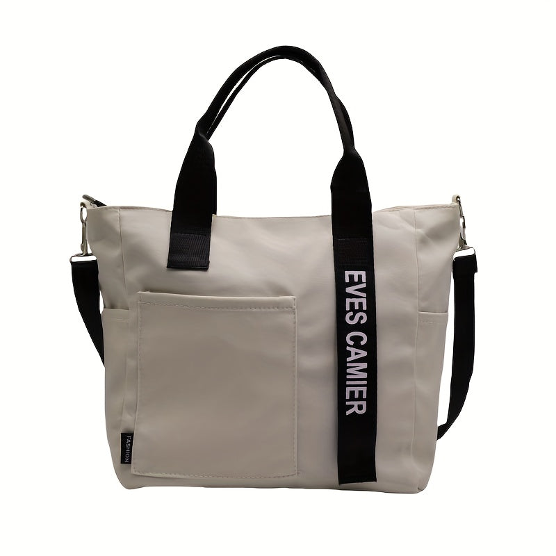 Borsa a tracolla beige con manici neri, tasca frontale e scritta "EVES CAMIER". Design moderno, ideale per moda donna e accessori eleganti.