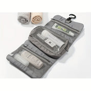 Borsa da viaggio grigia con gancio, scomparti a rete, contenente articoli da toeletta. Ideale per organizzare prodotti cosmetici e accessori.