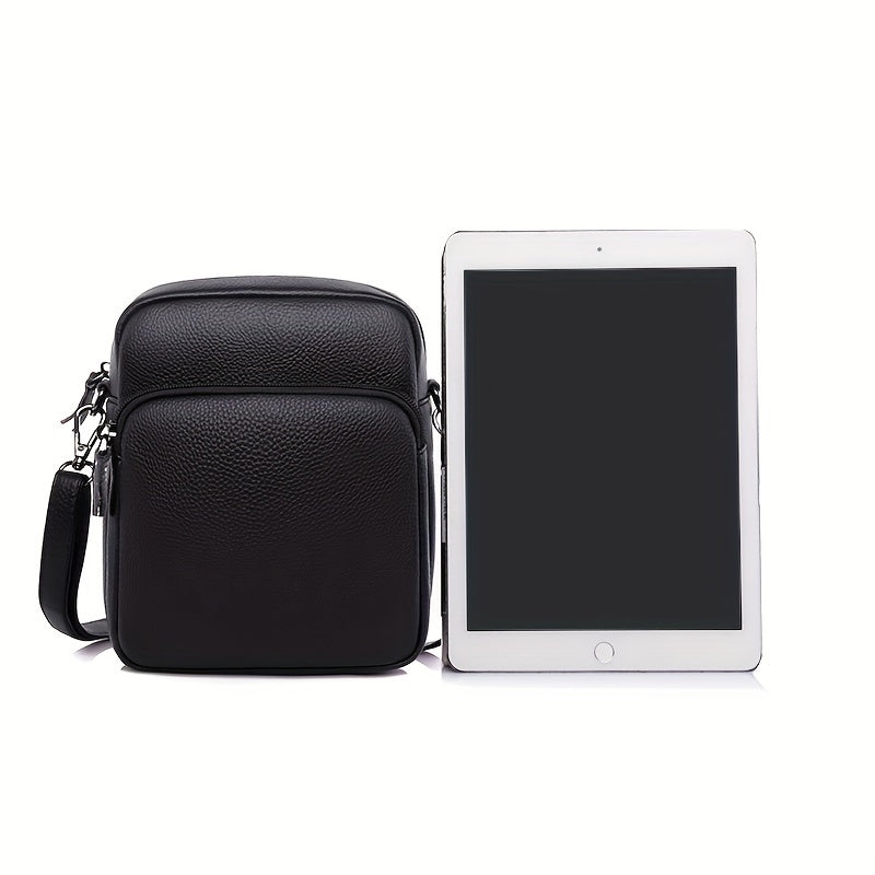Borsa a tracolla in pelle nera accanto a tablet, design elegante e compatto, ideale per uomo, accessorio moda, perfetto per lavoro e viaggio.