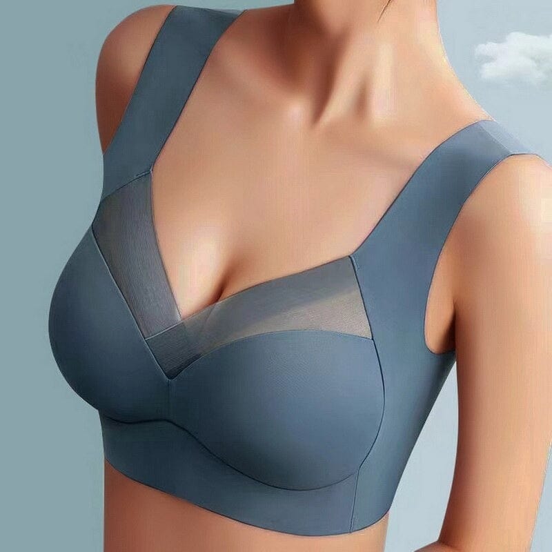 Reggiseno sportivo grigio con scollo a V e inserti in rete trasparente, design senza cuciture, supporto confortevole, ideale per attività sportive.