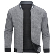 Giacca bomber uomo grigia, tessuto trapuntato, zip frontale, polsini e orlo a costine, tasca con zip sulla manica, stile casual elegante.
