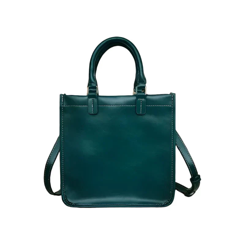 Borsa a mano in pelle verde scuro con manici e tracolla regolabile, design elegante e moderno, accessorio moda donna, shopping bag capiente.
